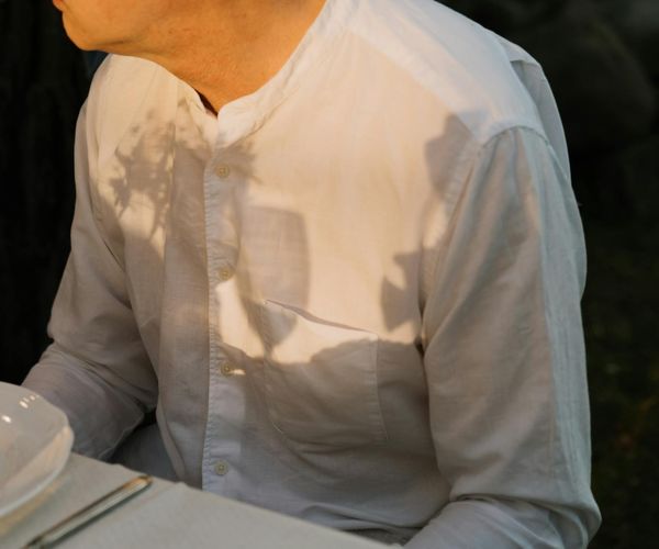A person meditating peacefully in a natural outdoor setting.